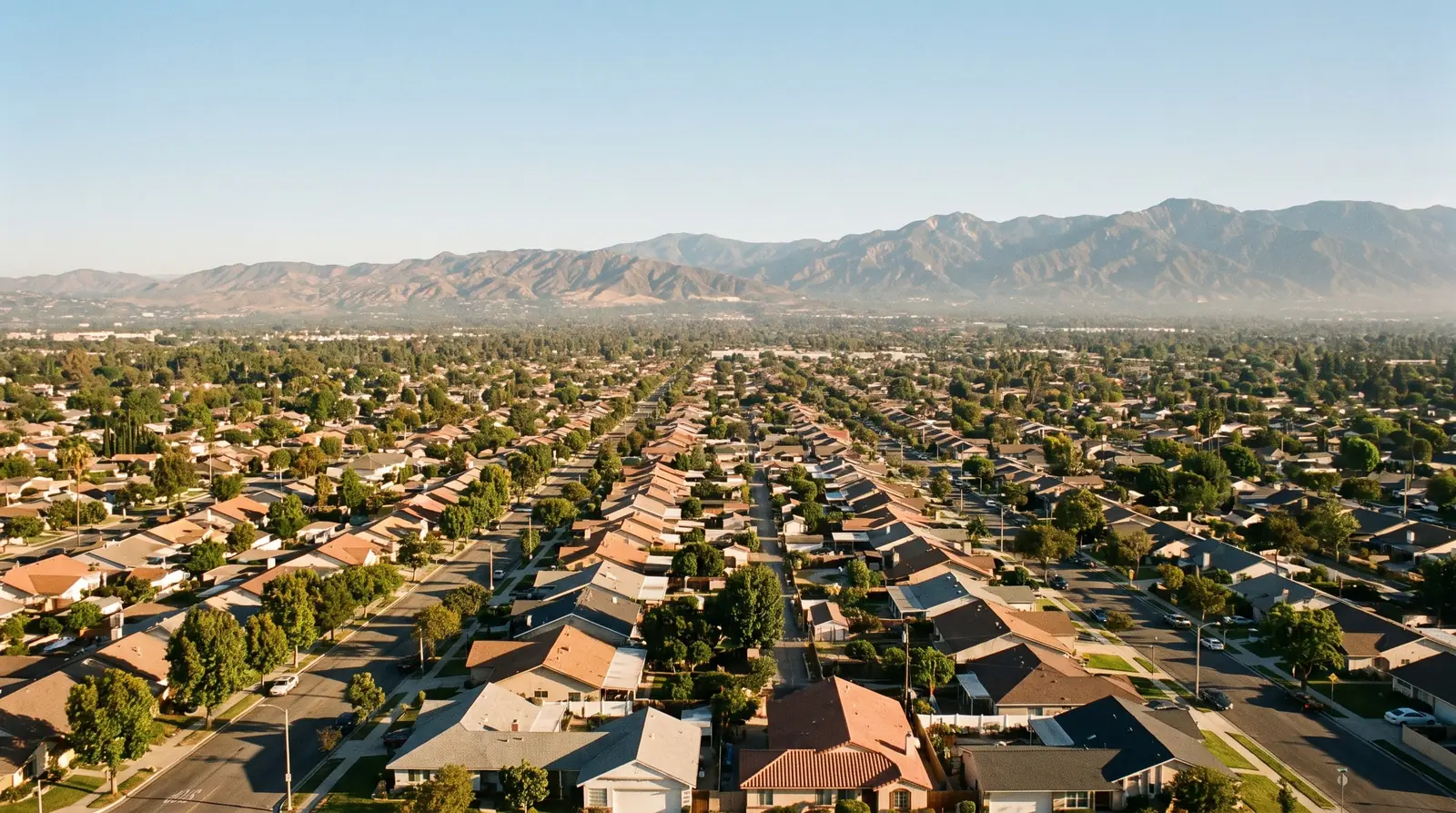 Areas served across Los Angeles County: suburban streets of the San Fernando Valley running toward the San Gabriel Mountains in morning sun